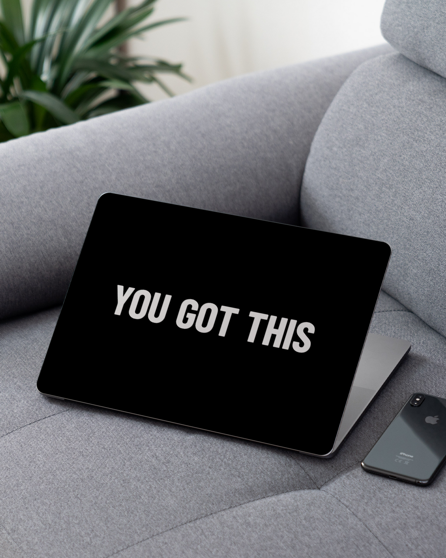 You Got This Black Laptop Skin for 13 inch Apple MacBooks on a couch