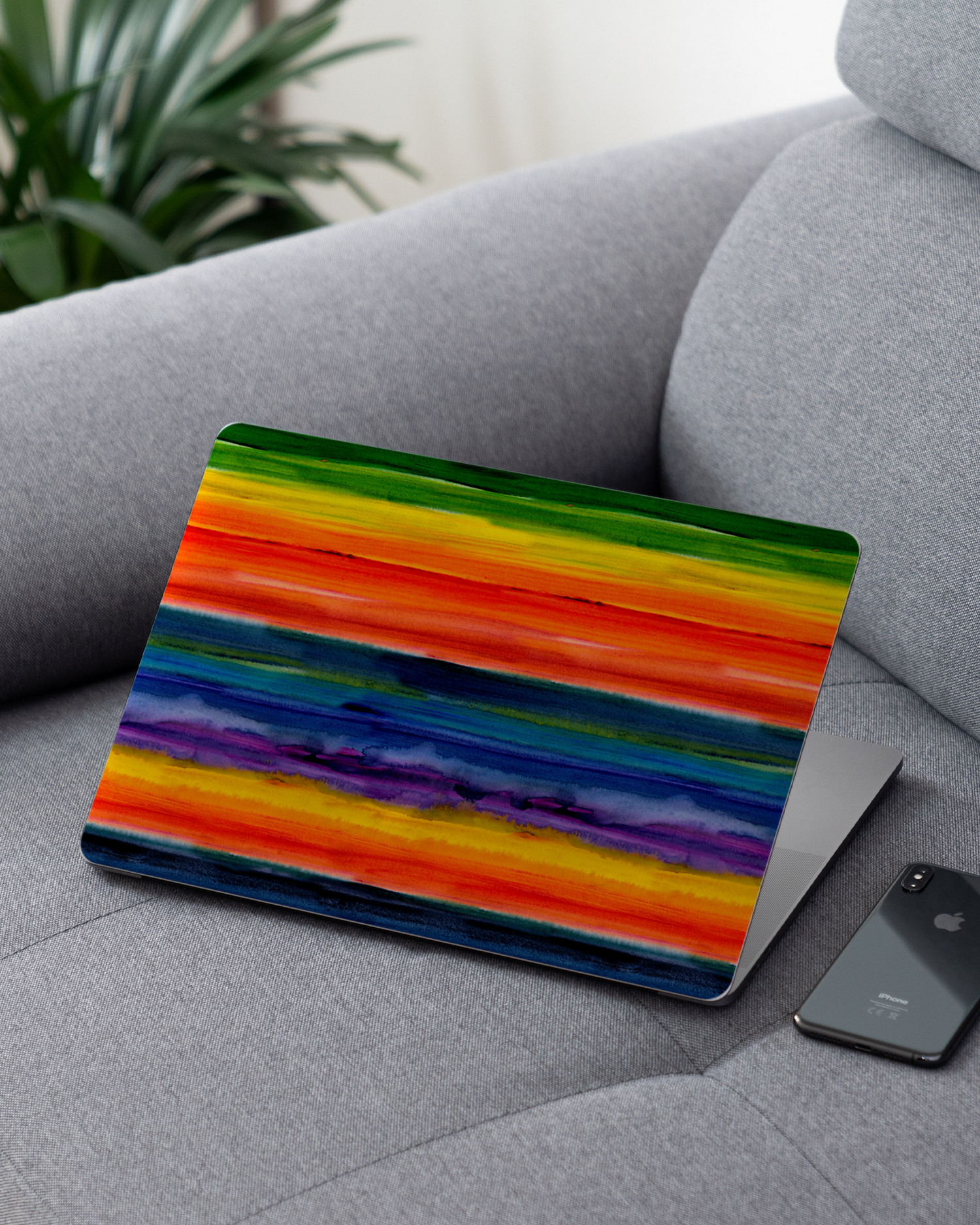 Striped Tie Dye Laptop Skin for 13 inch Apple MacBooks on a couch