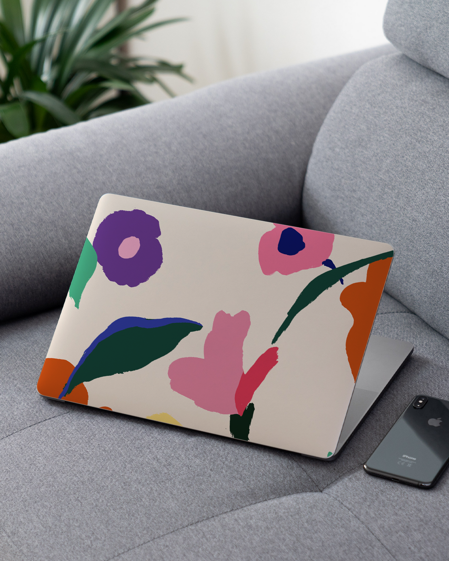Handpainted Blooms Laptop Skin for 13 inch Apple MacBooks on a couch