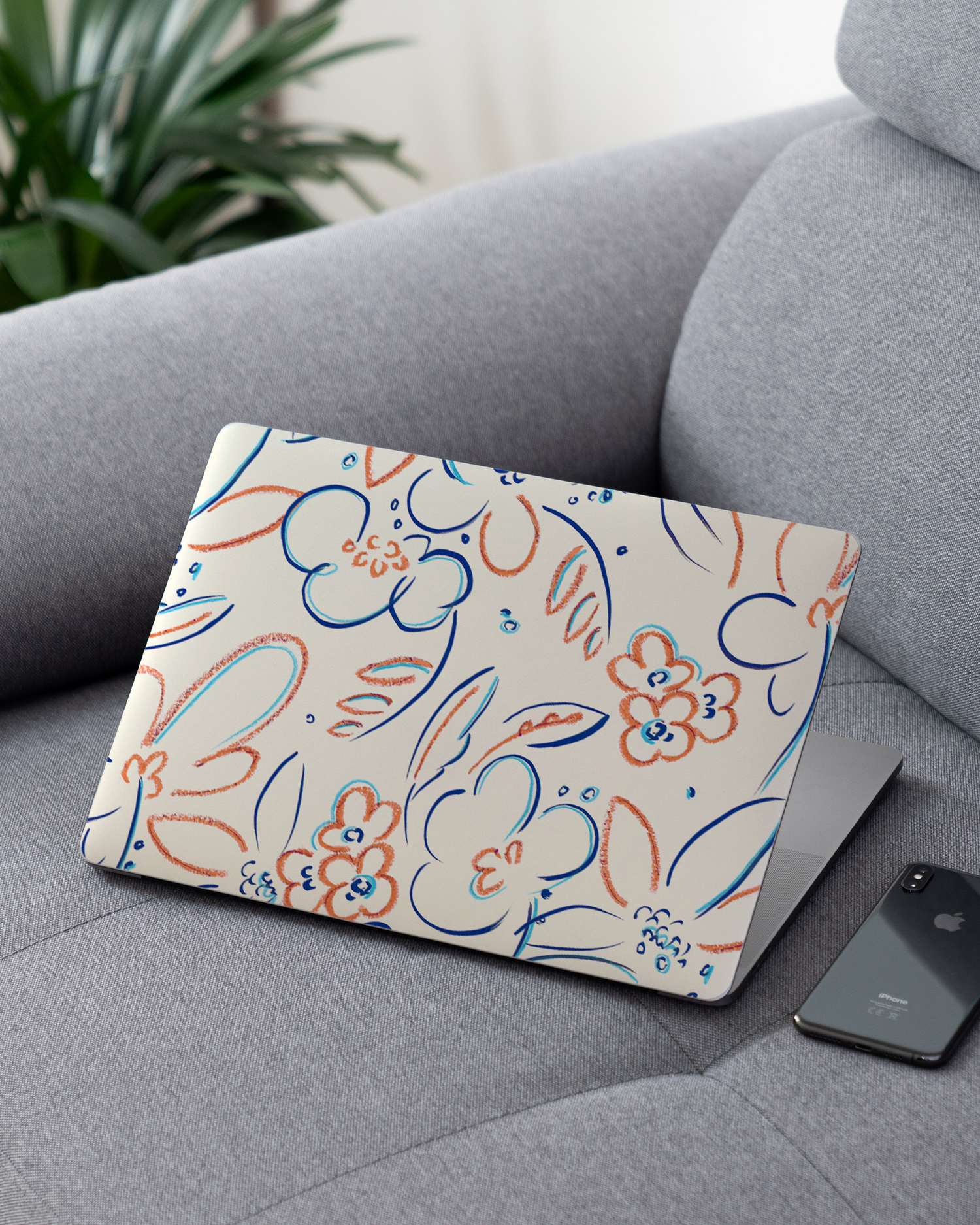 Bloom Doodles Laptop Skin for 13 inch Apple MacBooks on a couch
