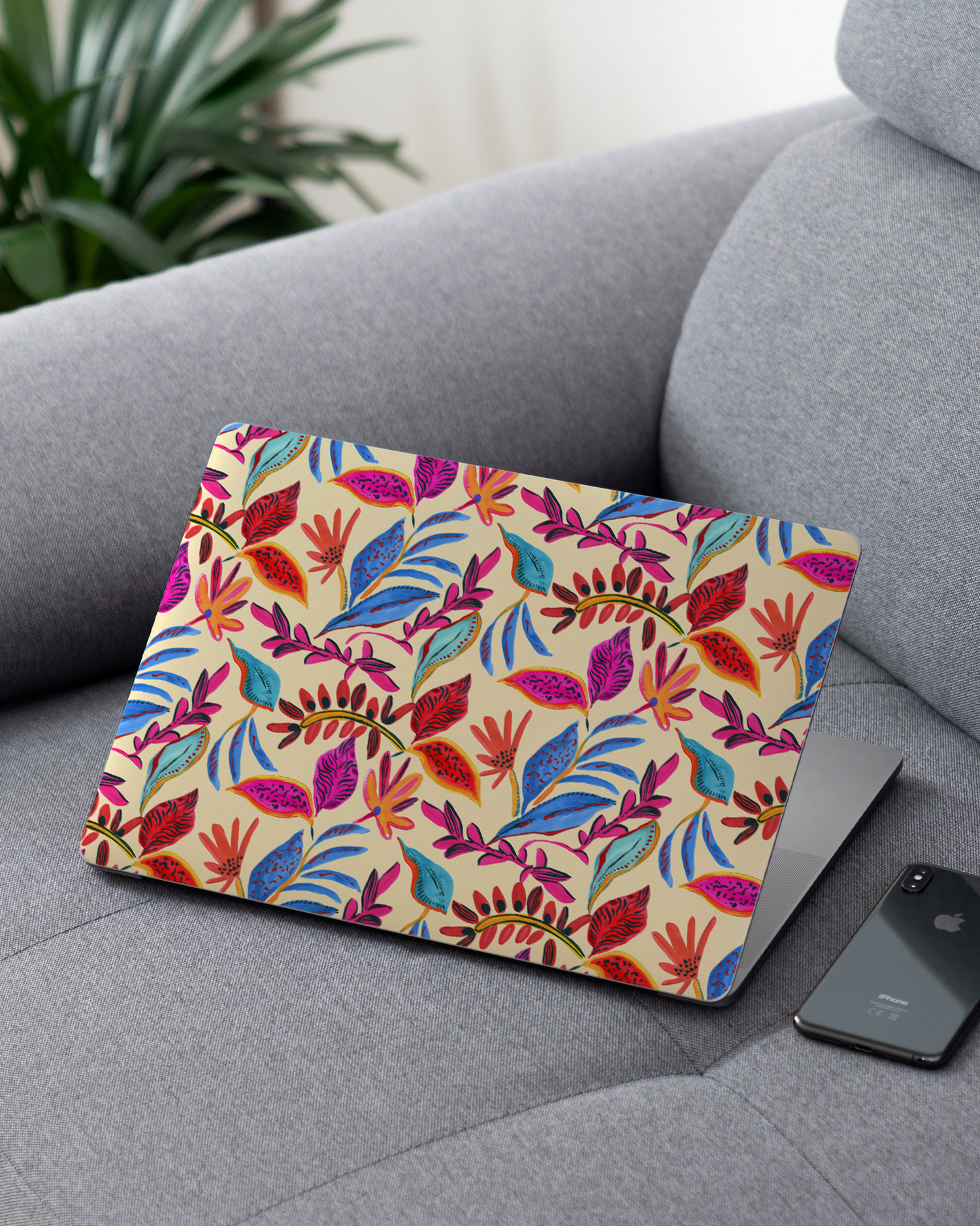 Painterly Spring Leaves Laptop Skin for 13 inch Apple MacBooks on a couch