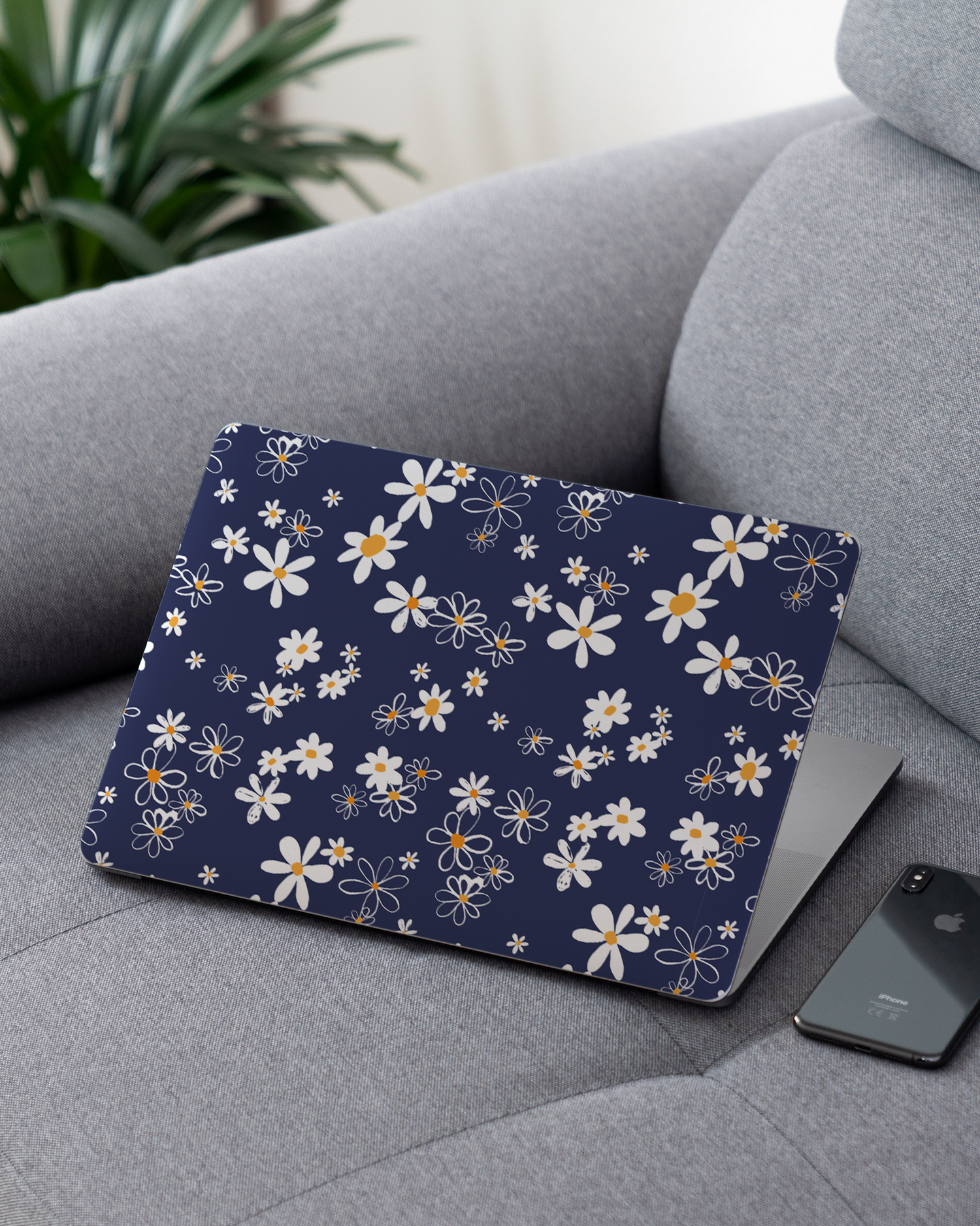 Navy Daisies Laptop Skin for 13 inch Apple MacBooks on a couch