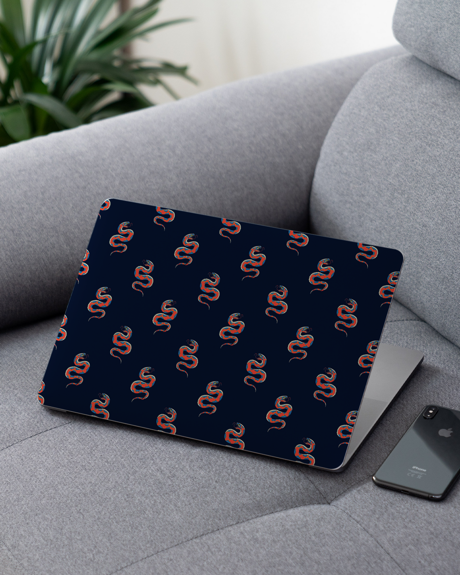 Repeating Snakes Laptop Skin for 13 inch Apple MacBooks on a couch