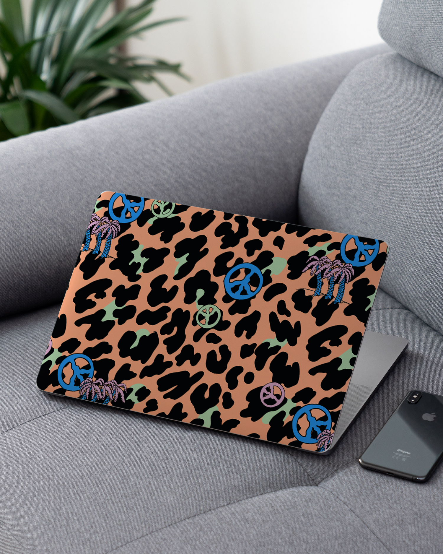Leopard Peace Palms Laptop Skin for 13 inch Apple MacBooks on a couch