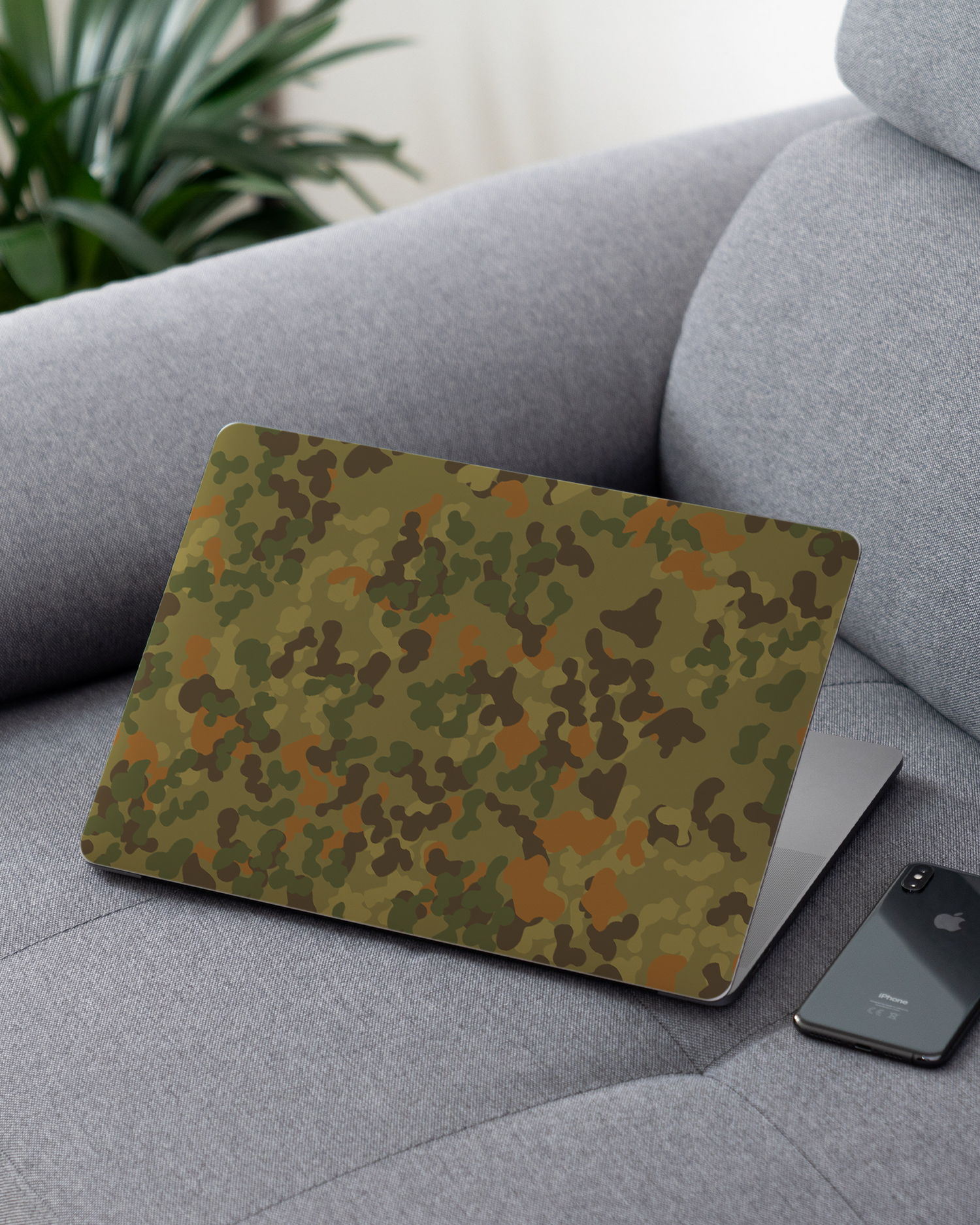 Spot Camo Laptop Skin for 13 inch Apple MacBooks on a couch