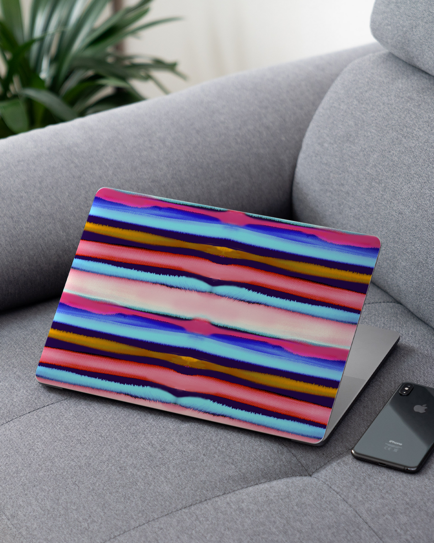 Watercolor Stripes Laptop Skin for 13 inch Apple MacBooks on a couch