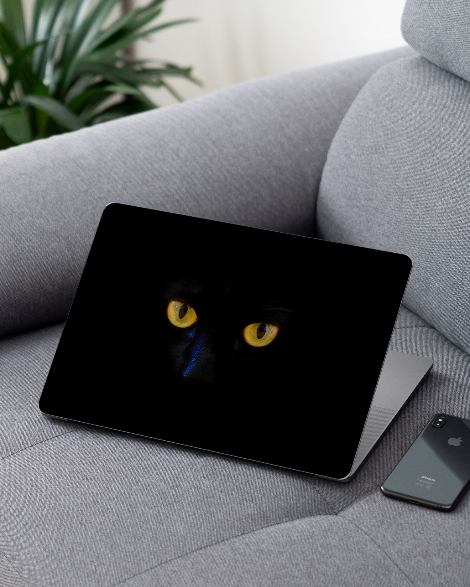Black Cat Laptop Skin for 13 inch Apple MacBooks on a couch