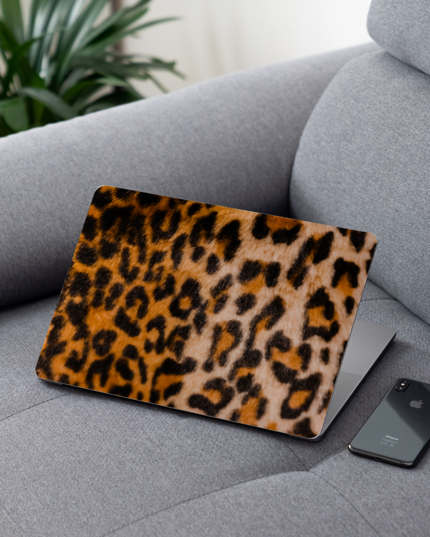 Leopard Pattern Laptop Skin for 13 inch Apple MacBooks on a couch