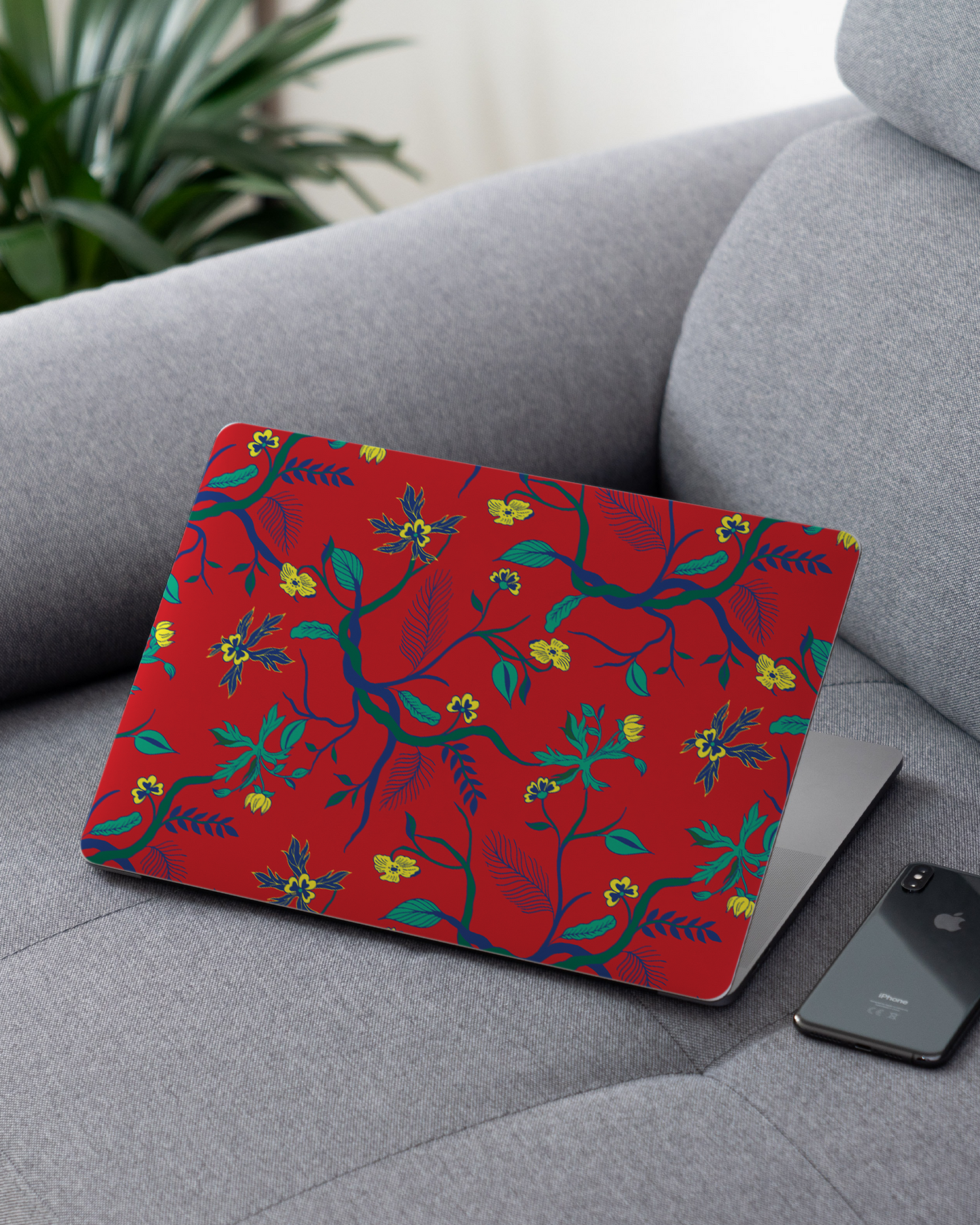 Ultra Red Floral Laptop Skin for 13 inch Apple MacBooks on a couch