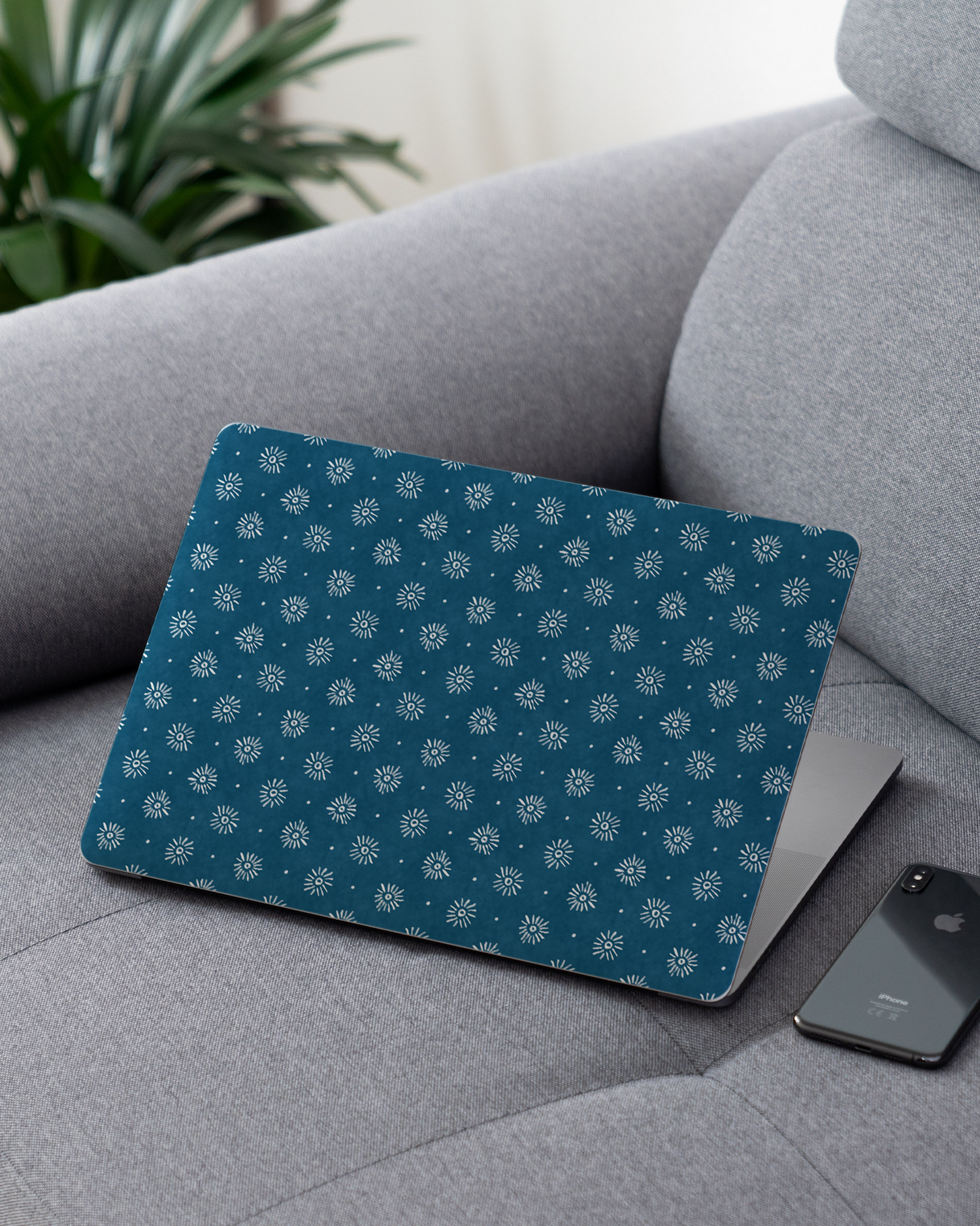 Indigo Sun Pattern Laptop Skin for 13 inch Apple MacBooks on a couch
