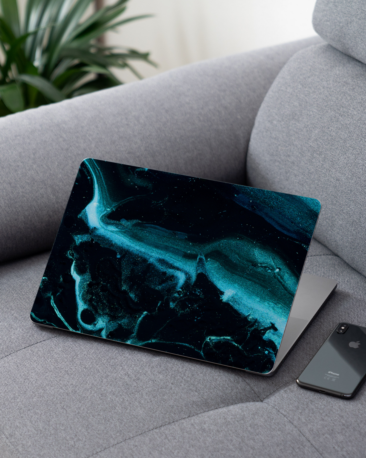 Deep Turquoise Sparkle Laptop Skin for 13 inch Apple MacBooks on a couch